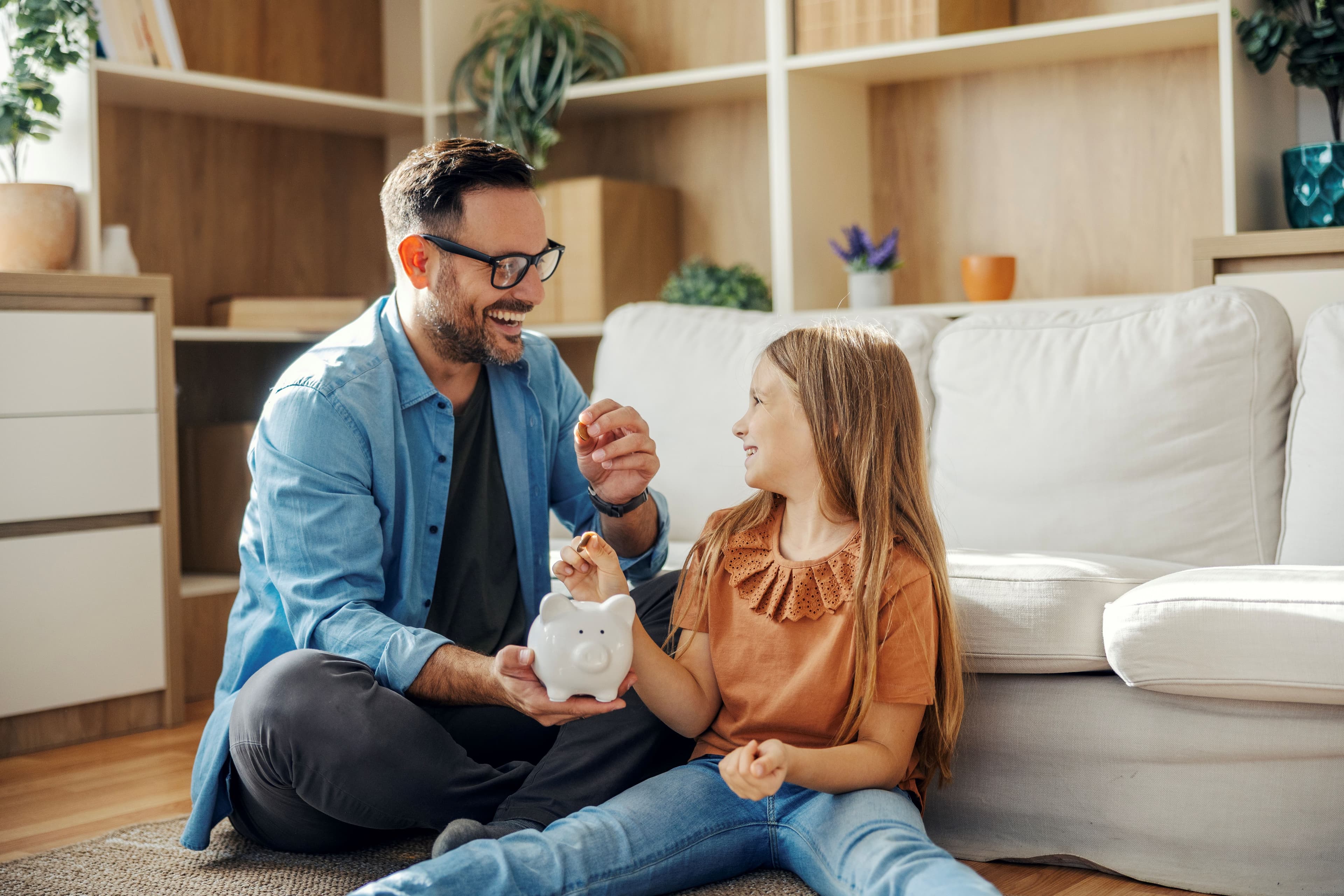 Father and daughter saving money